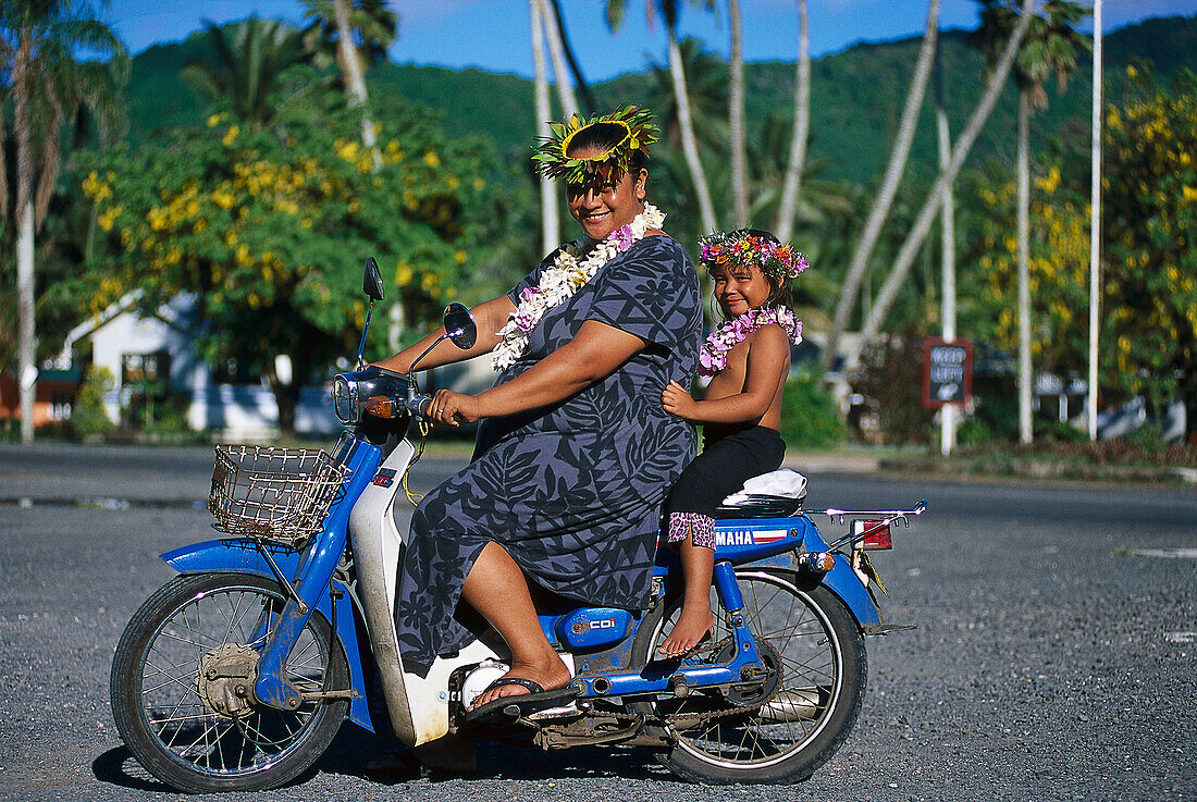 Woman and child on a moped, Avaruna, Rarotonga, Cook Islands, South Pacific