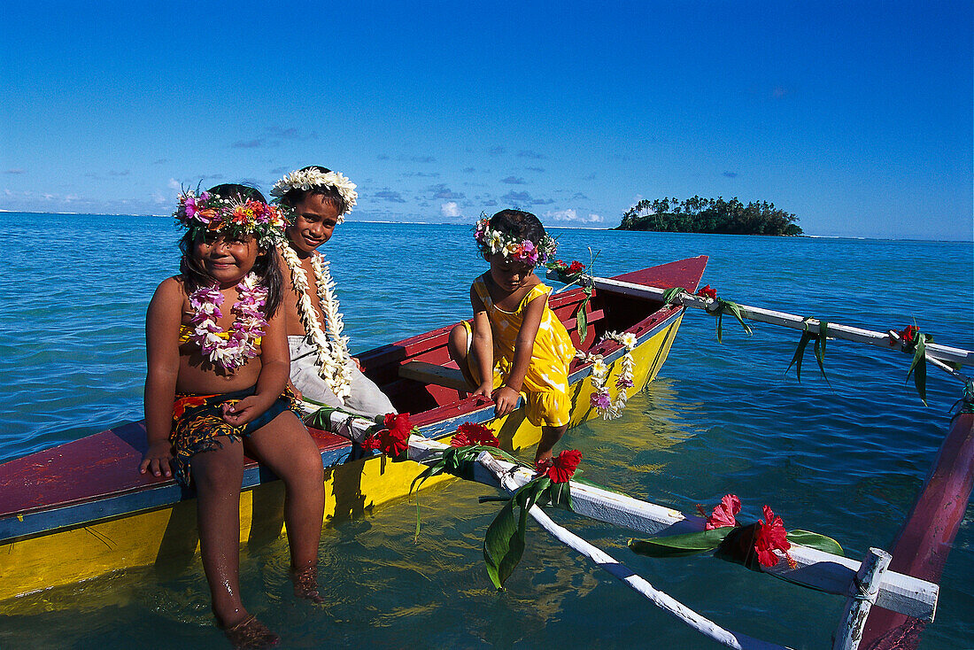 Three girls in a canoe, Muri Beach, Rarotonga, Cook Islands, South Pacific
