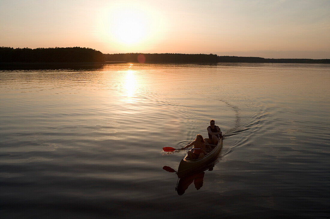 Couple Canoeing at Sunset, Lake Zotzensee, Mecklenburgian Lake District, Germany