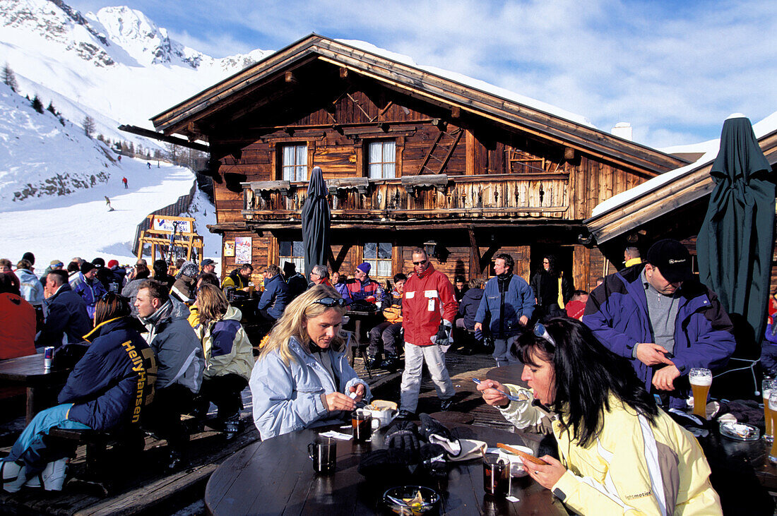 People in front of a ski hut, Gampe alp, Soelden, Oetz Valley, Tyrol, Austria, Europe