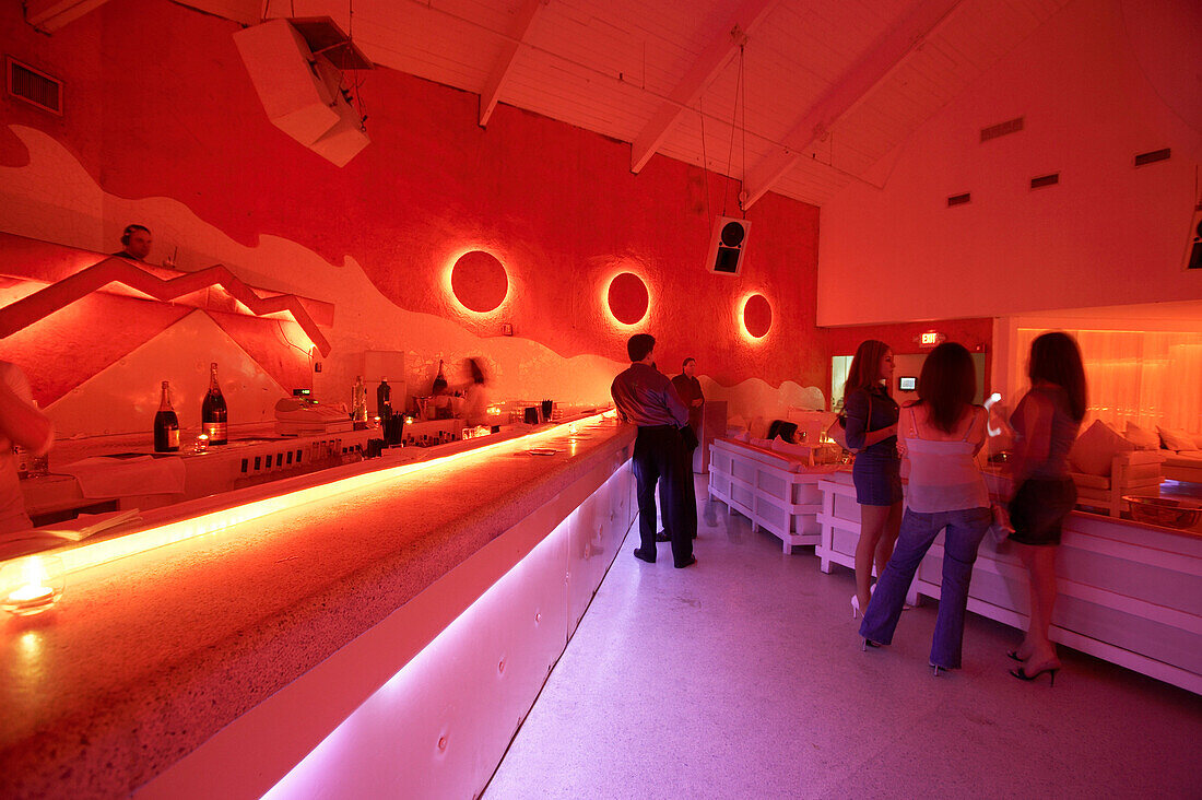 Guests in coloured light at Pearl, South Beach, Miami Florida, USA