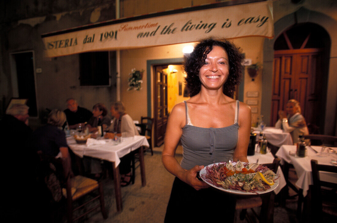 Woman with seafood, Capoliveri, Elba, National Park of the Tuscan Archipelago, Tuscany, Italy