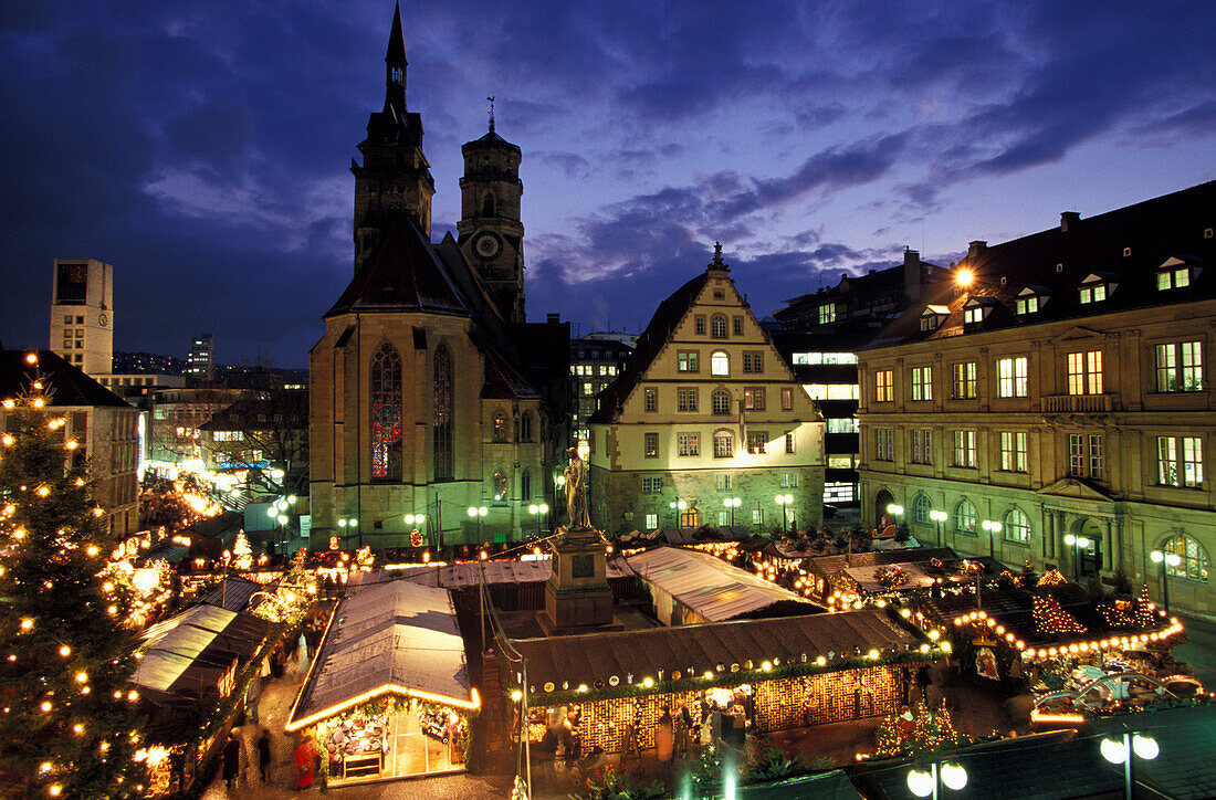 Christmas market on the Square Karlsplatz with church Stiftskirche and Schiller monument, Stuttgart, Germany