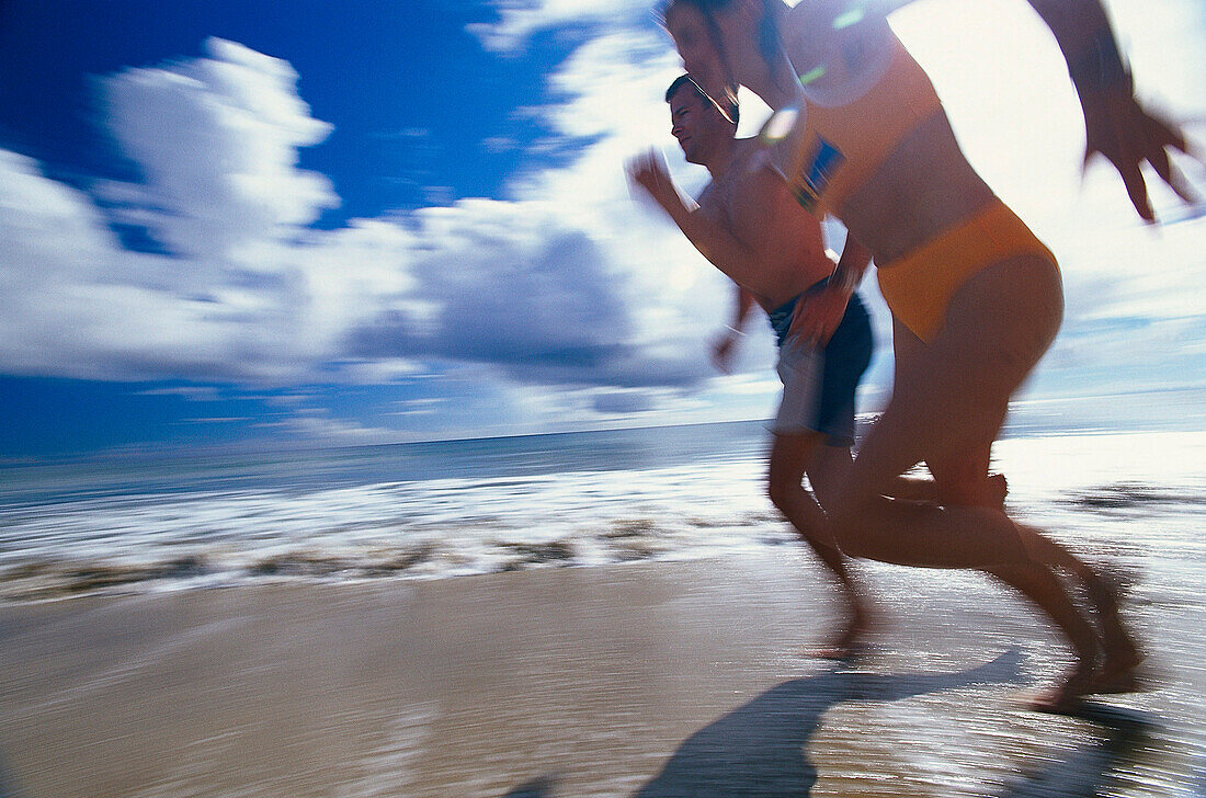 Couple jogging on beach, Madeira, Portugal