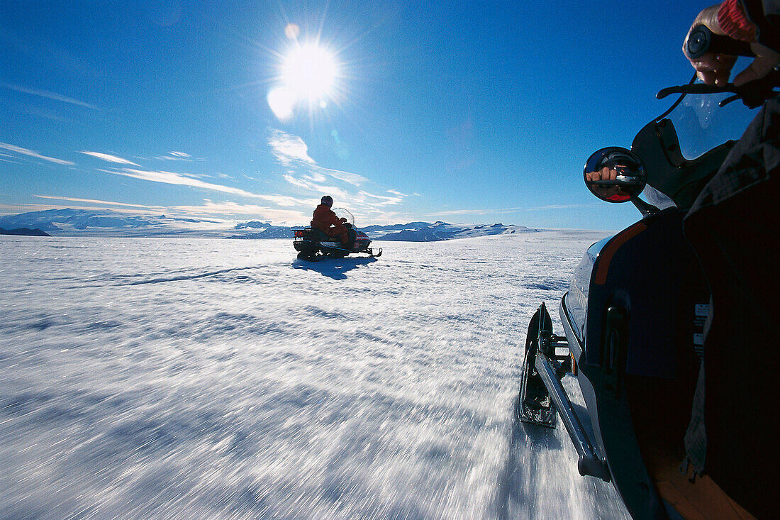 Person driving a snowmobil on Bruarjoekull, a strip of land at Vatnajoekull, Island