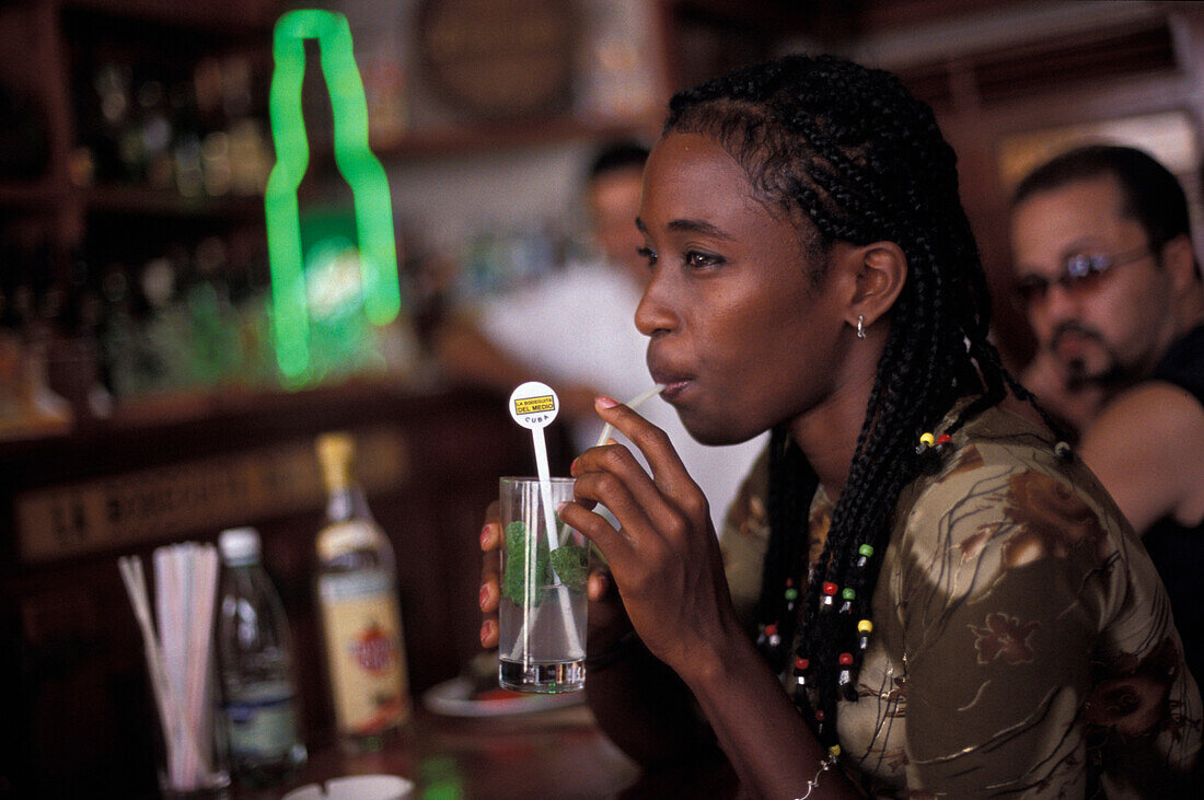 Young woman with drink at a bar, La Bodeguita del Medio, Havana, Cuba, Caribbean, America