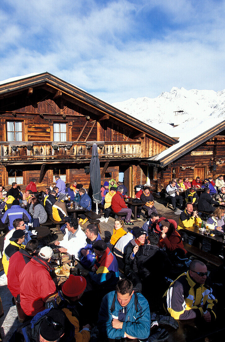 Gampe Alp, people sitting outside a ski hut, Soelden, Oetztal, Tyrol, Austria