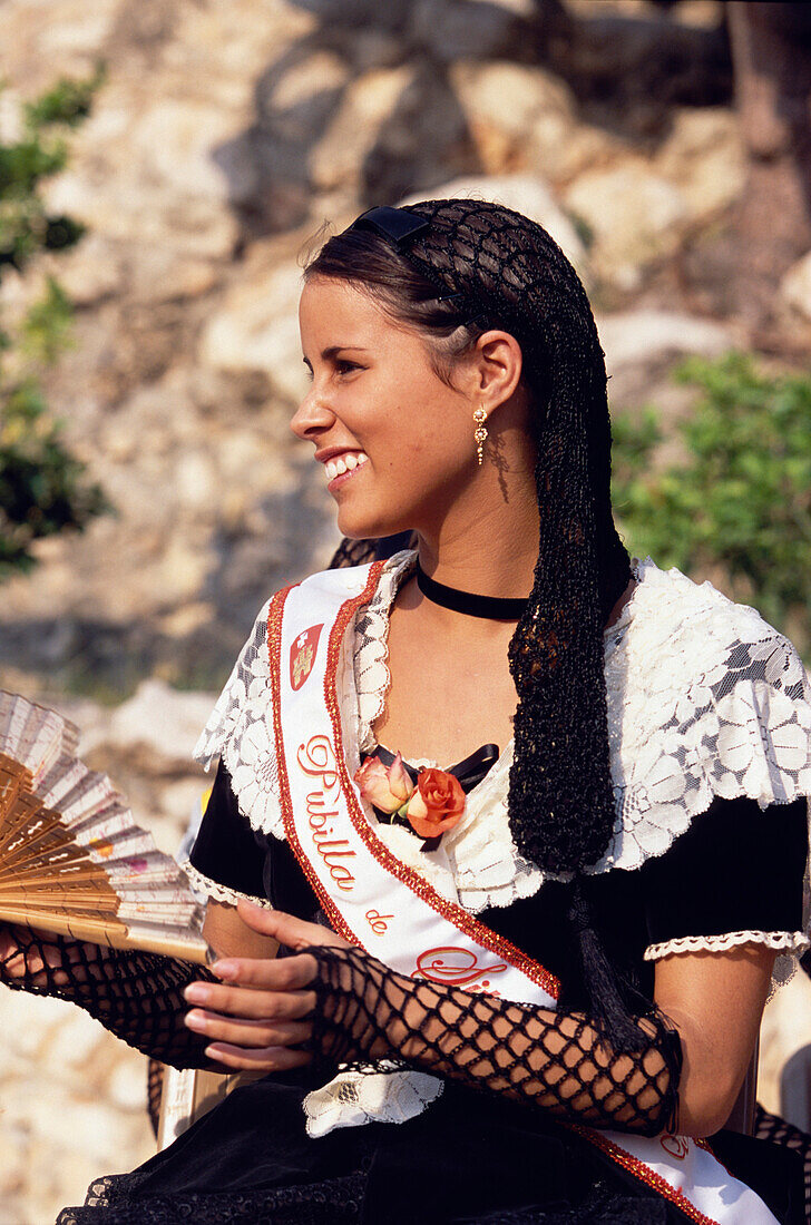 Young women in traditional dress representing different villages at the Wine Festival in Sitges, Costa de Garraf, Spain