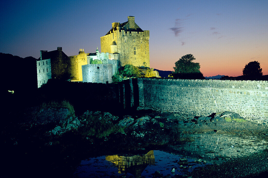 The illuminated Eilean Donan castle at night, Ross and Cromarty, Highlands, Scotland, Great Britain, Europe