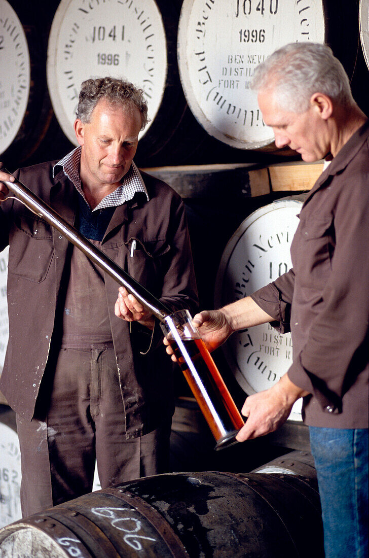 Two men testing whiskey at Ben Nevis distillery, Fort William, Invernesshire, Scotland, Great Britain, Europe