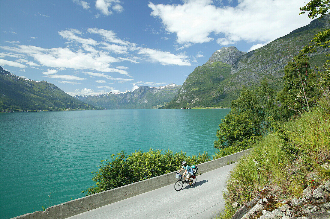 Woman with child on a bike, Lake Sryn, Sogn og Fjordane, Norway