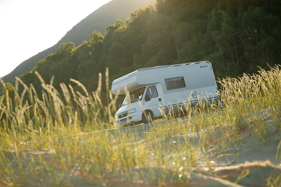 Motorhome on the beach of lake vaga, near Lom, Oppland, Norway