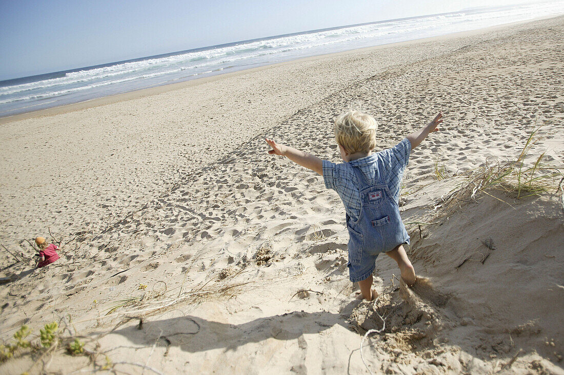 Little boy running down the dunes, Natures valley, Tsitsikamma National park, Western Cape, South Africa