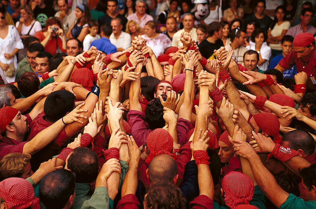 Castellers forming the base of a castell, human tower, during the Wine Festival, Benissalem, Mallorca, Majorca, Balearic Islands, Spain