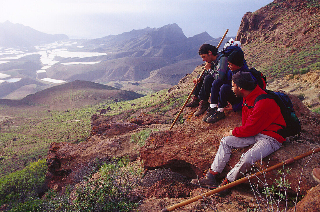 Three hikers in Tamadaba-San Nicolás, Gran Canaria, Canary Islands, Spain