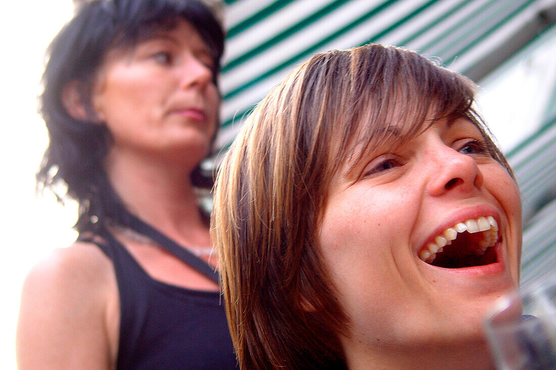 Lachende junge Frau in Café, Berlin, Deutschland