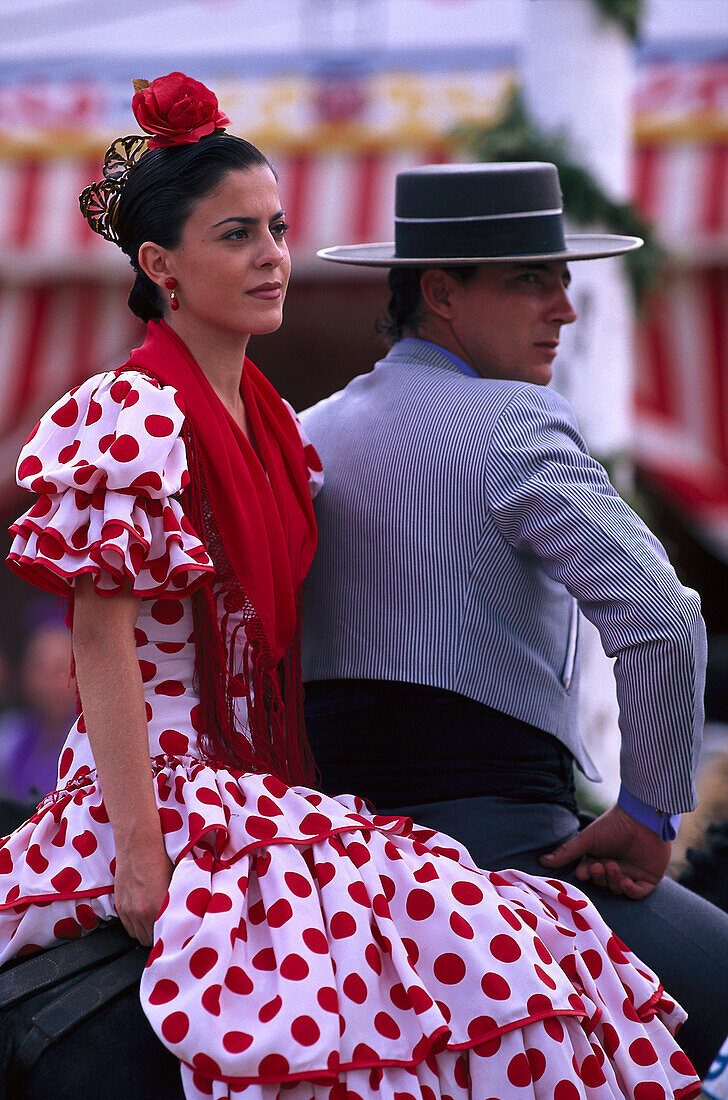 Middle-aged couple in traditional costumes on horseback, Romeria de San Isidro, Nerja, Costa del Sol, Malaga province, Andalusia, Spain, Europe