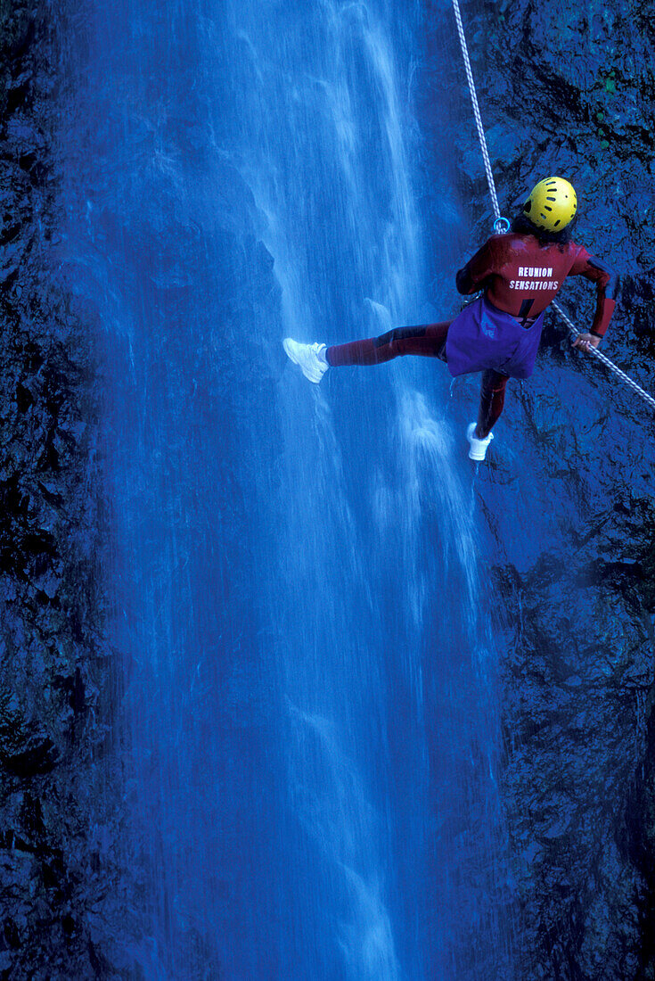 Person canyoning at Gobert Waterfall, Cilaos, La Réunion, Indian Ocean