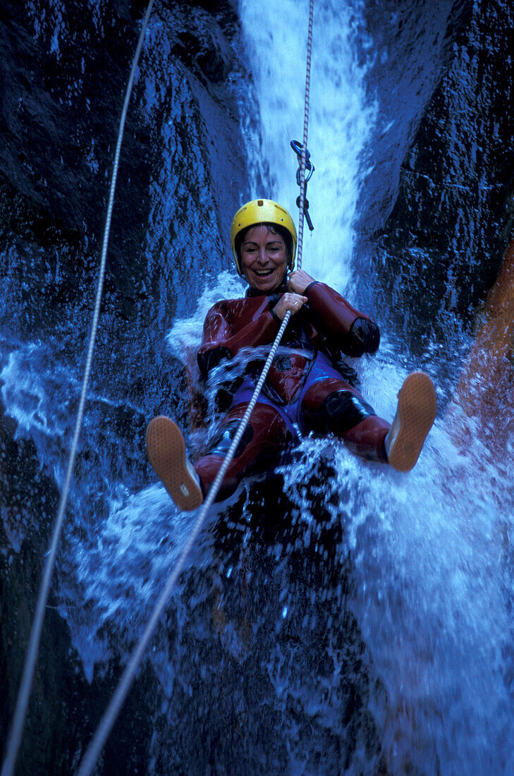 Person canyoning at the Gobert Waterfall, Cilaos, La Réunion, Indian Ocean