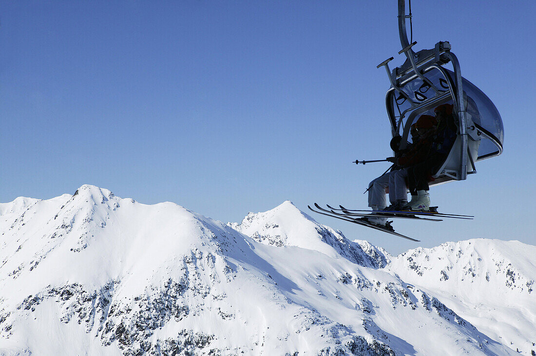 Skier in chair lift, Kuhtai, Tyrol, Austria