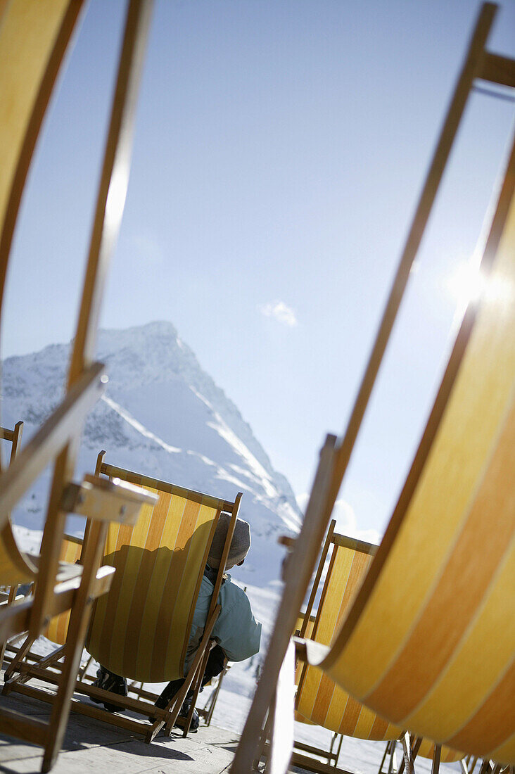 Woman relaxing in deck chair, Hohe Mut in backround, Kuehtai, Tyrol, Austria