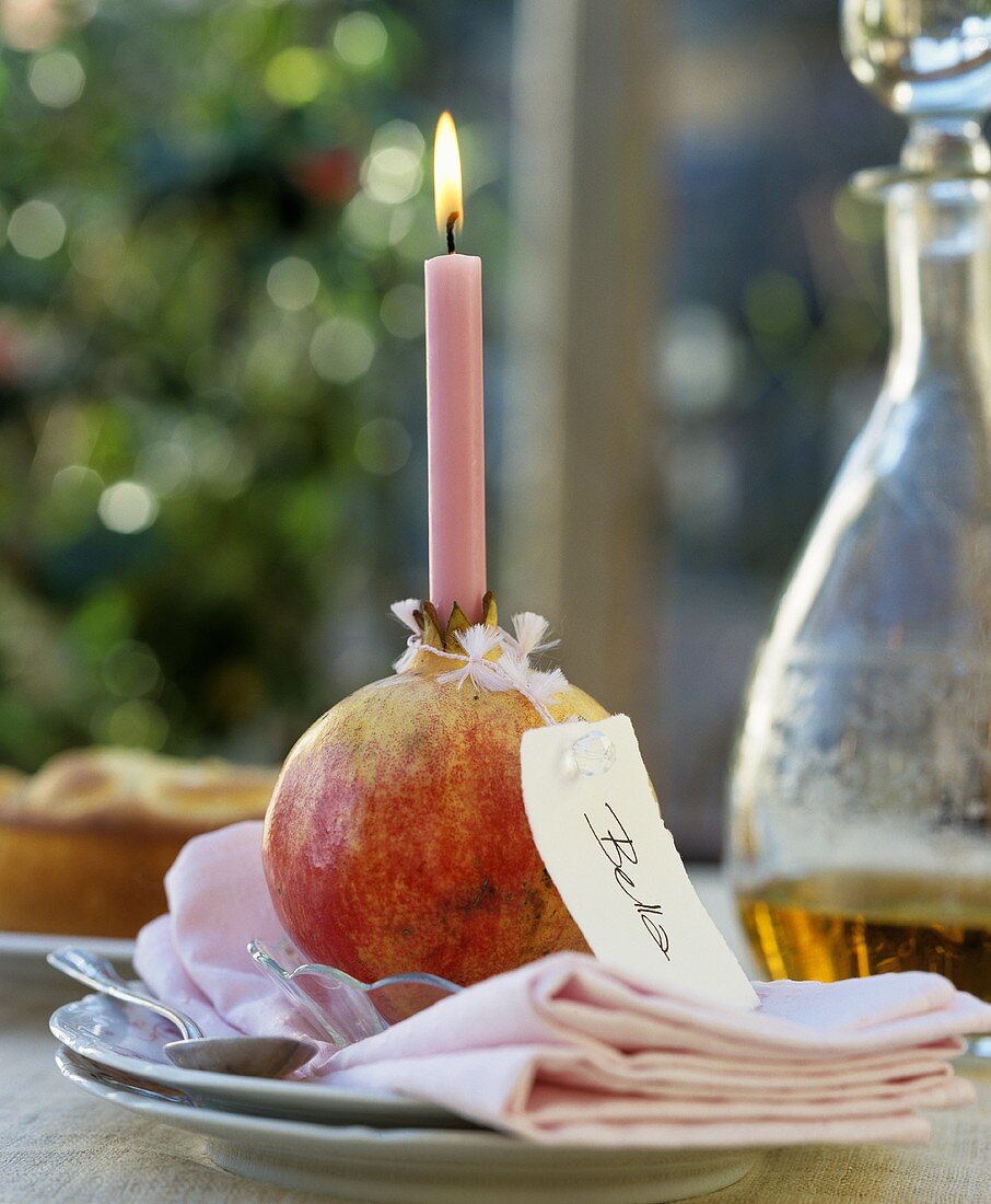 A pomegranate as a candle holder