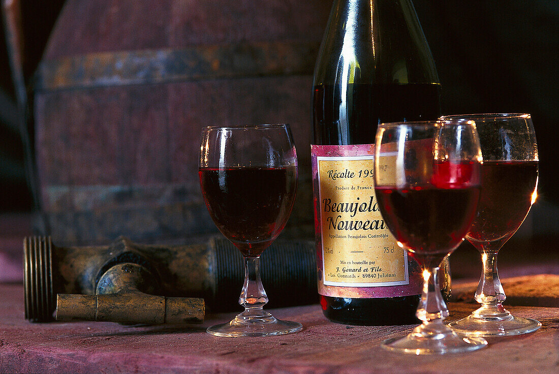 Bottle of Beaujolais primeur with three glasses, Beaujolais, Red wine, France