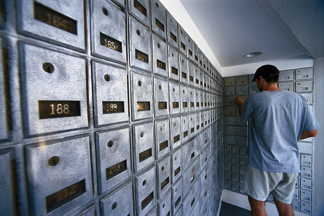 Man opening a post office box, Finance, Tax, George Town, Cayman Islands