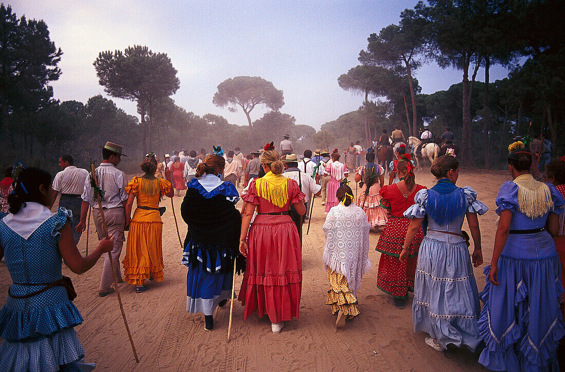 Pilgrims walking along sandy road, Andalusia, Spain