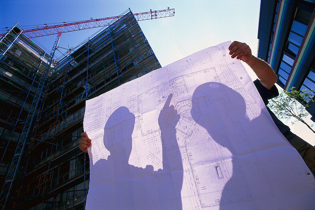 Two construction workers holding plan, building Site Biotechnology Martinsried, Bavaria, Germany