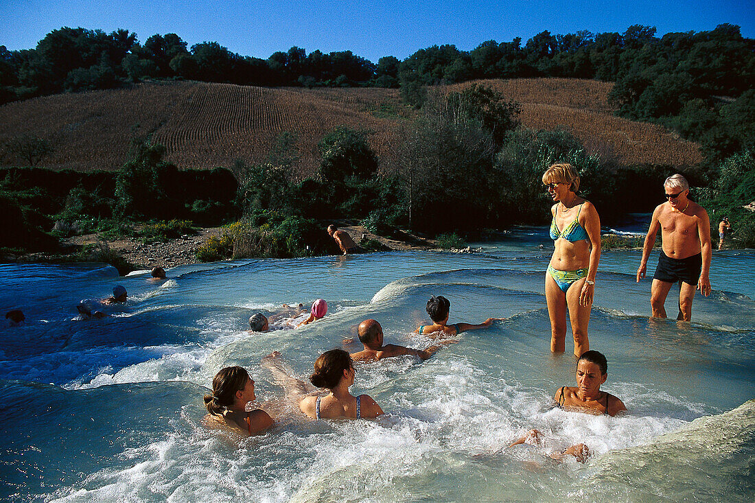 Swimming people, Cascade, Cascate del Mulino Thermalwater, Saturnia, Tuscany, Italy