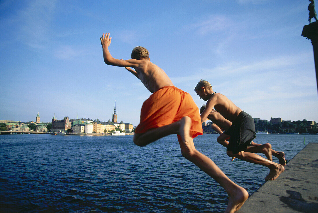 Boys jumping into water, Stockholm, Sweden
