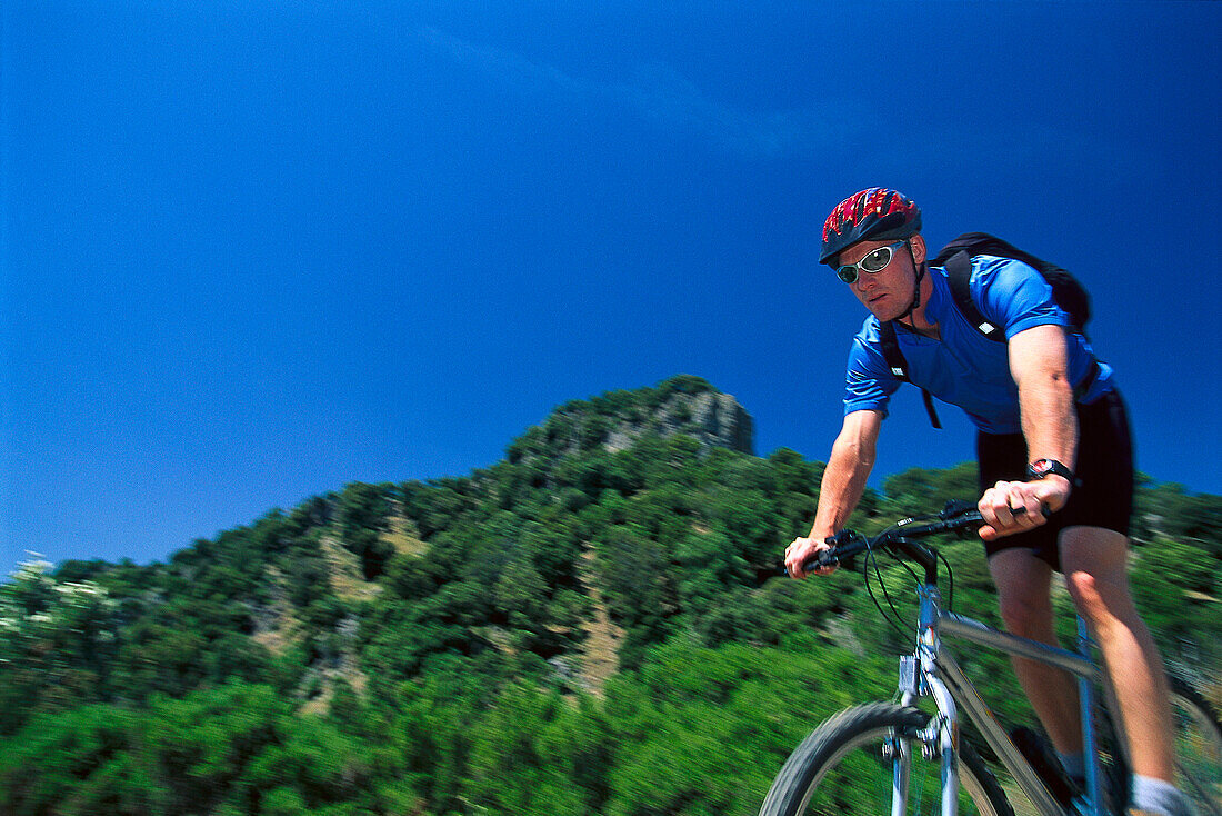 Male mountainbiker passing, Sardinia, Italy