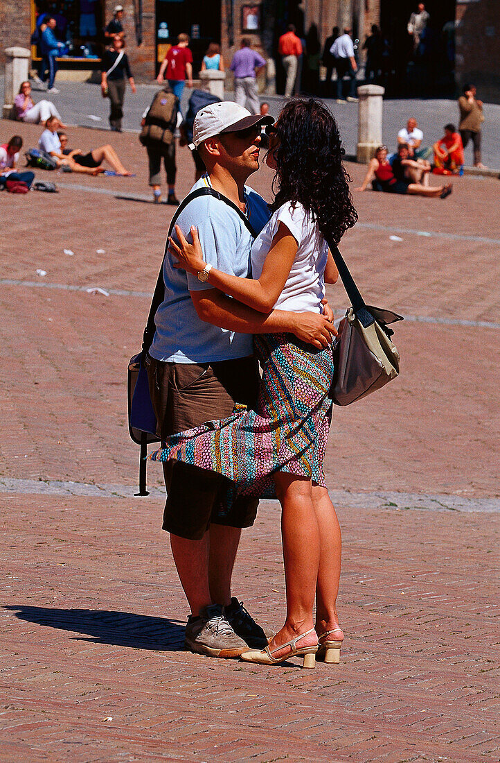 Hugging couple at Piazza del Campo, Siena, Tuscany, Italy