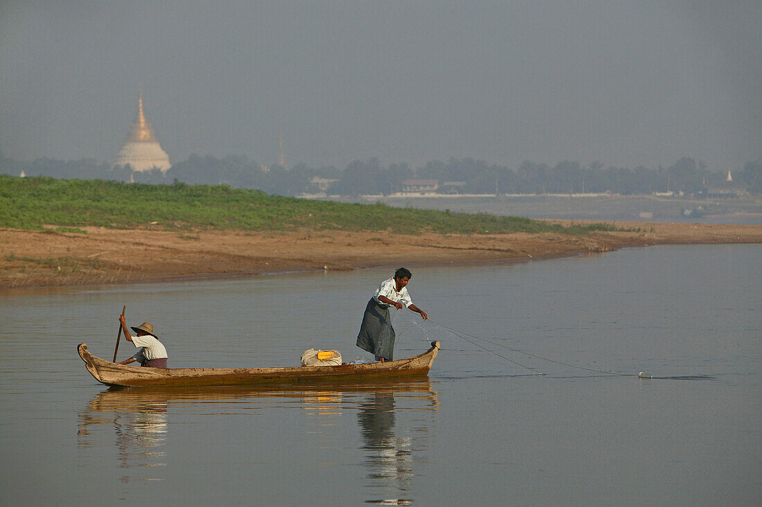 fishermen in small boat on river, Myanmar