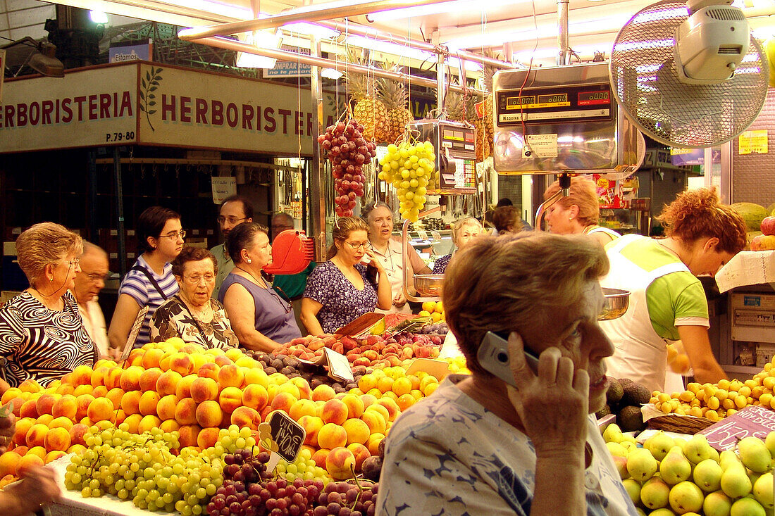 Women at a market stand at the market hall, Valencia, Spain, Europe