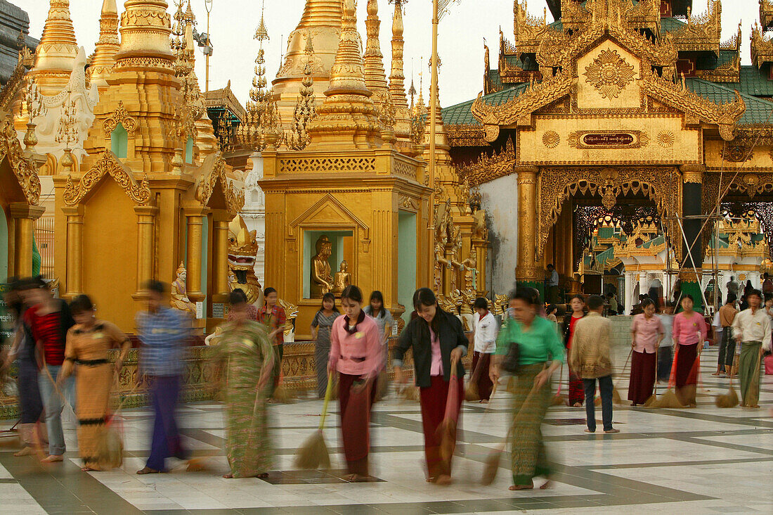 women sweeping to gain merit for the next life, Shwedagon Pagoda, Myanmar, Burma