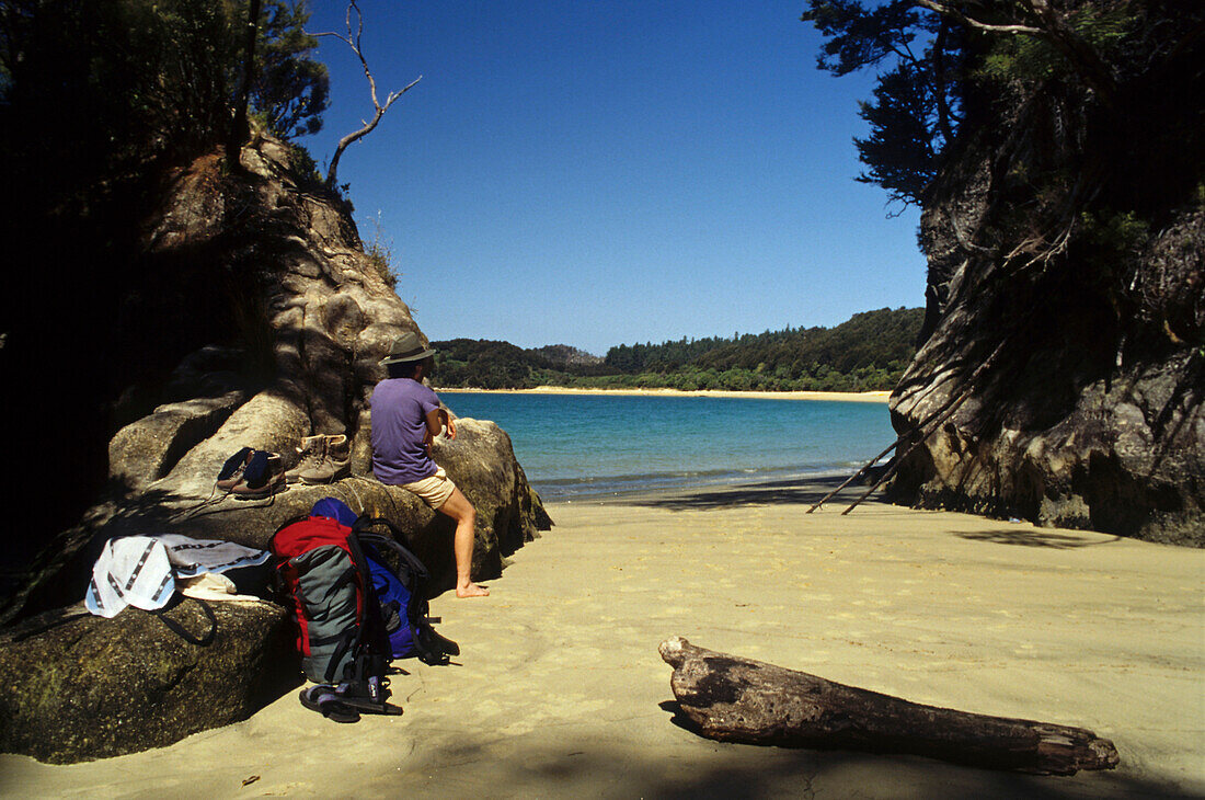Hiker in a sunny bay, Abel Tasman Coast Track, Torrent Bay, Abel Tasman National Park, New Zealand, Oceania