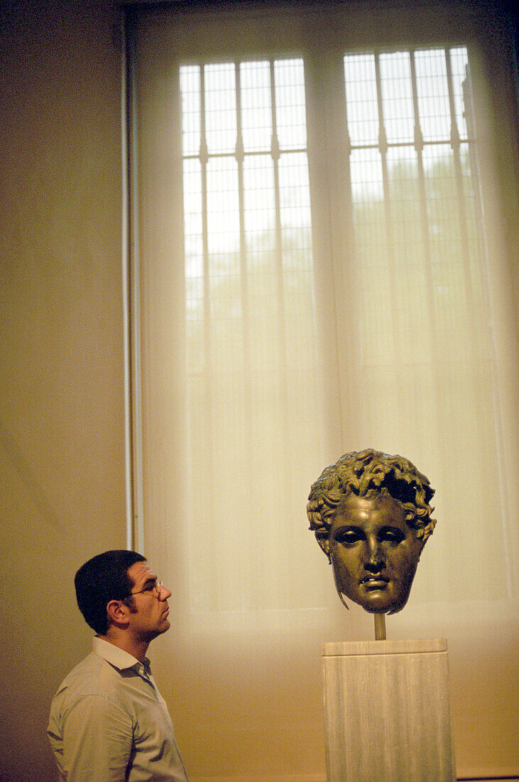 A man looking at a sculpture at the Prado, Madrid, Spain, Europe