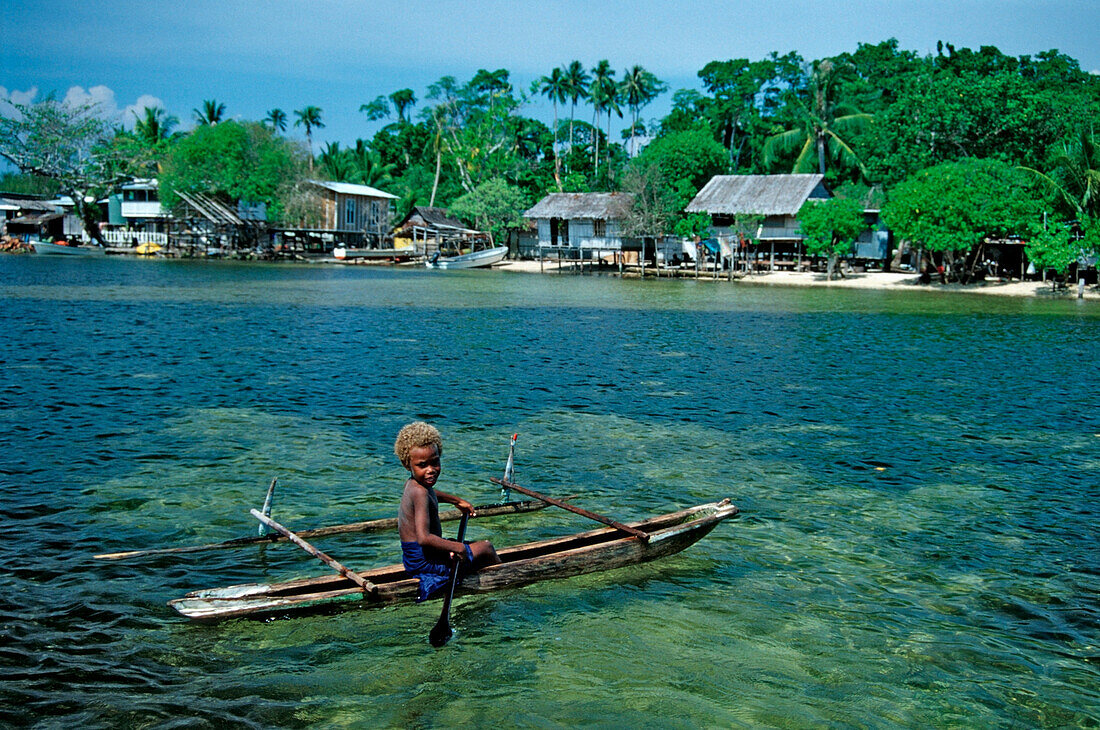 Child in an Outrigger boat, Papua New Guinea, New Ireland, Kavieng