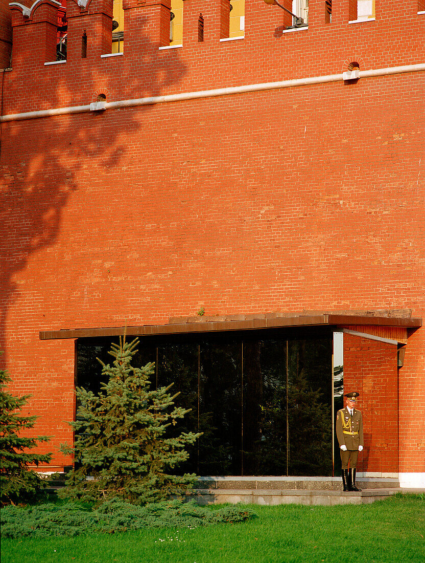 A guard standing in front of the Kremlin wall, Moscow, Russia