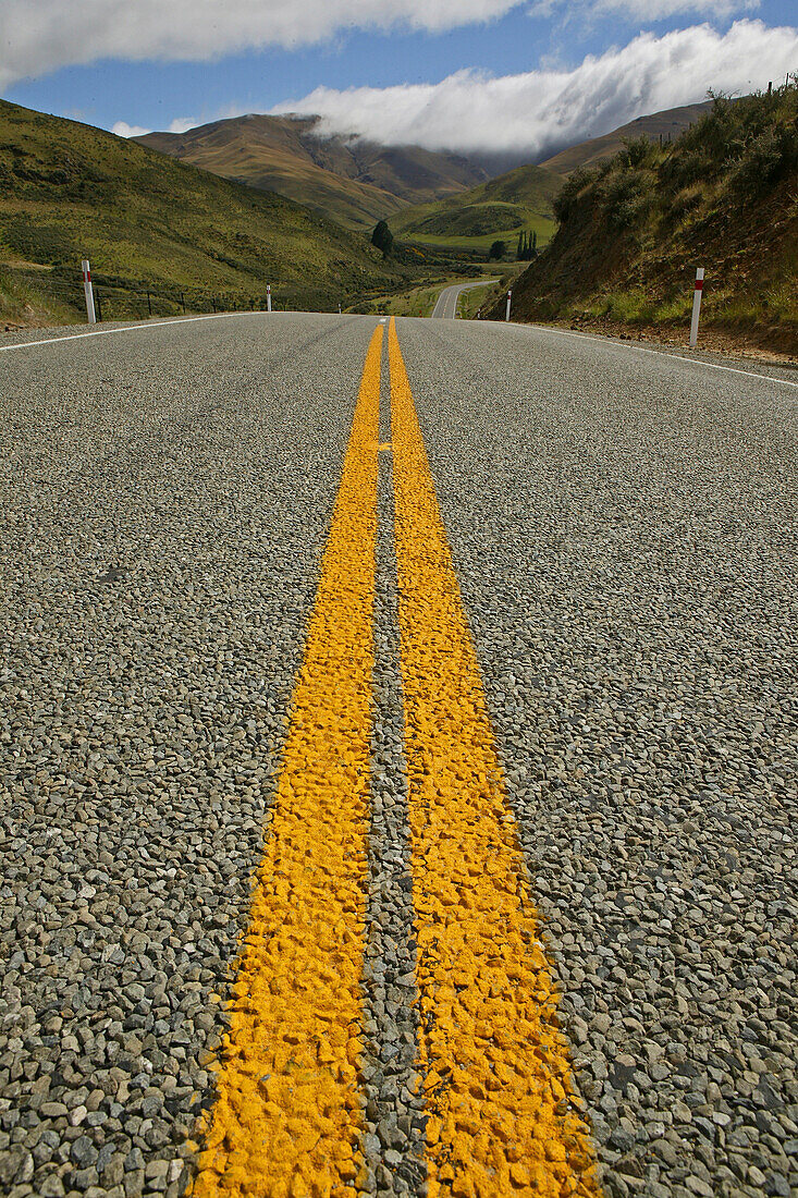 Yellow double medial strip on a country road in Otago, South Island, New Zealand, Oceania
