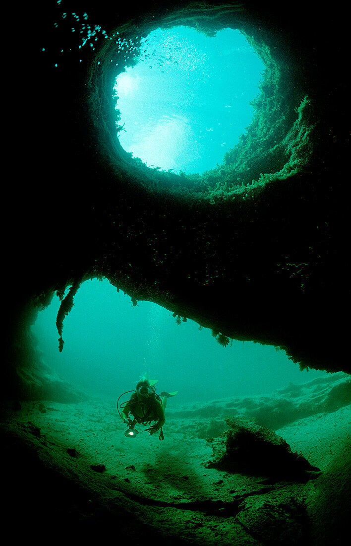 Scuba diver in underwater grotto, Bahamas, Freshwater Blue hole