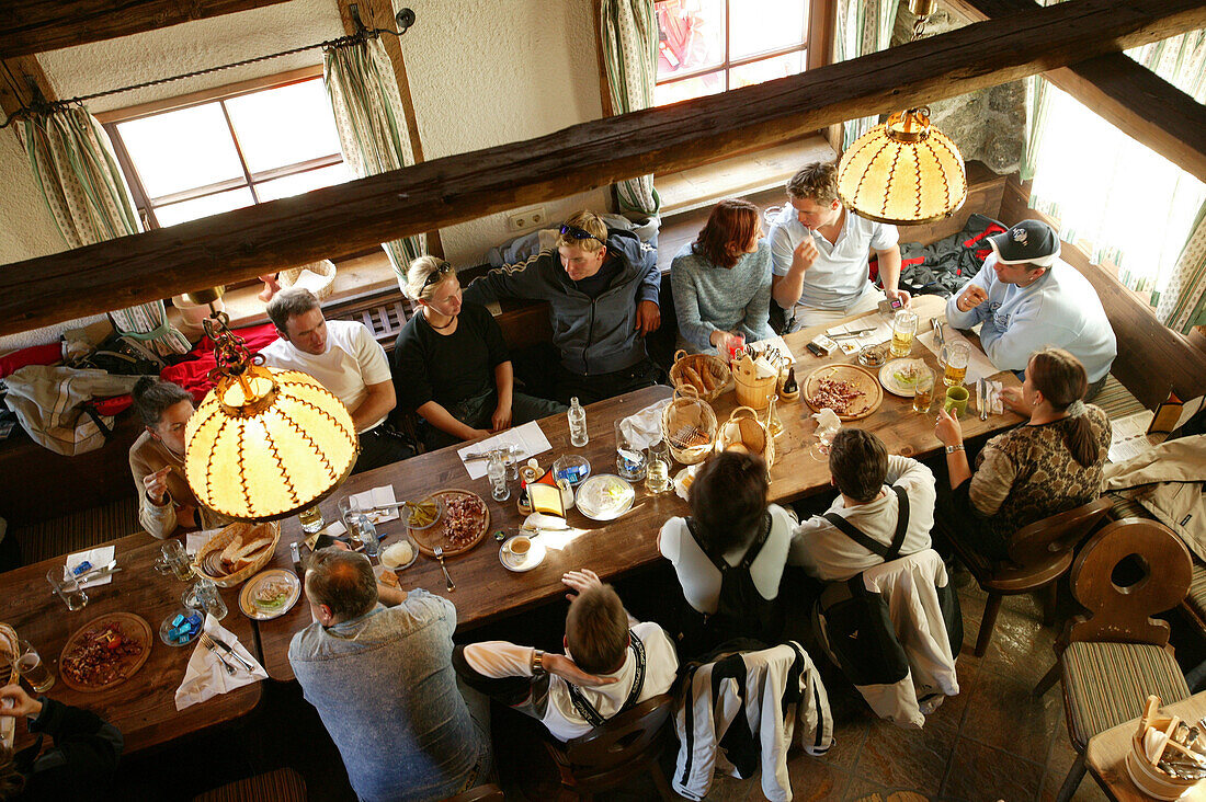 Group of people eating in ski hut Huehnersteign Soelden, Oetztal, Austria