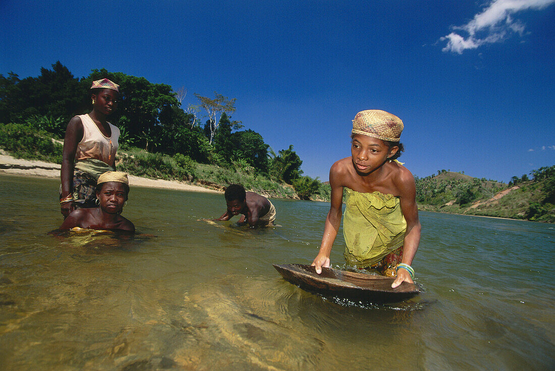 Women panning for gold, Washing gold out of a river, Namarona River, East Madagascar, Africa