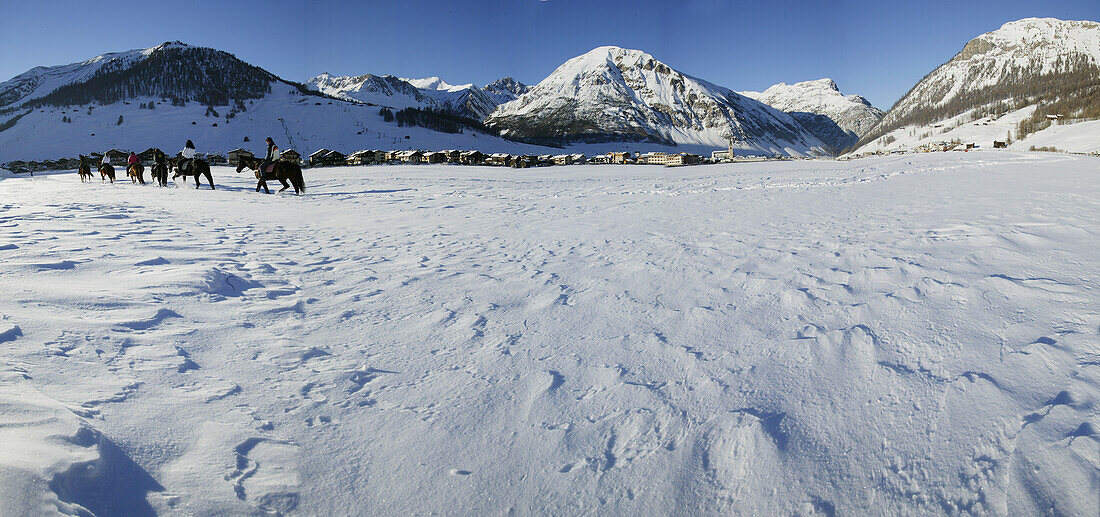 Horse riders in snow, Livigno, Italy