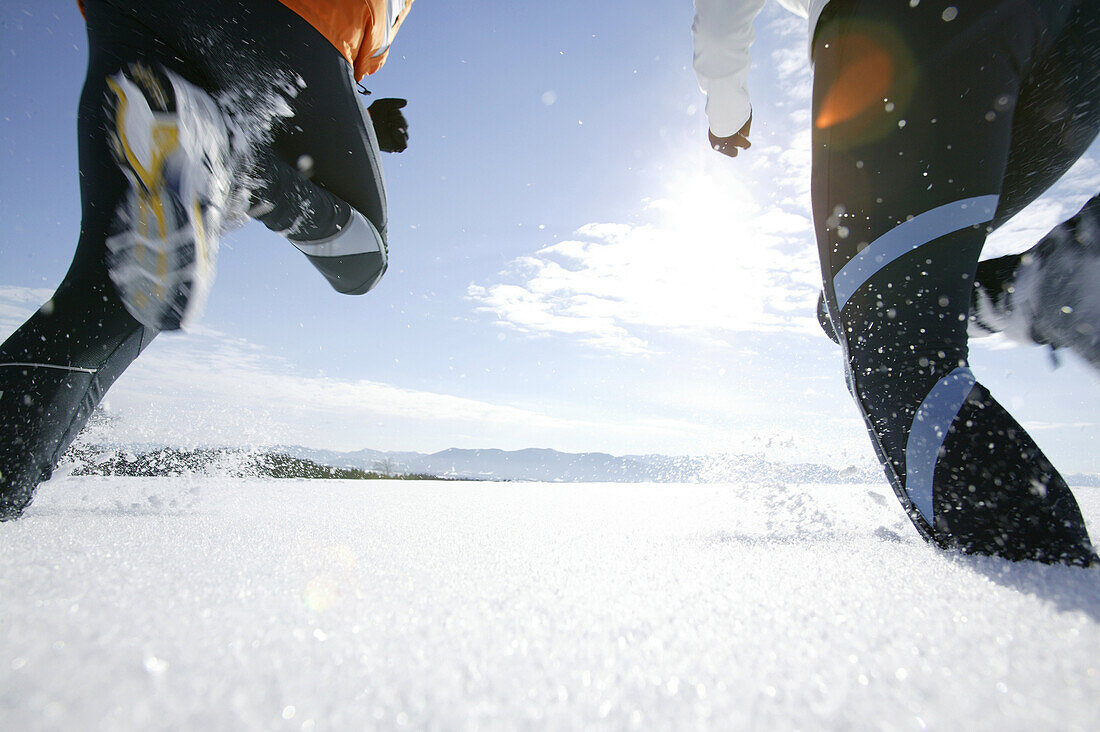 Young couple walking through powder snow