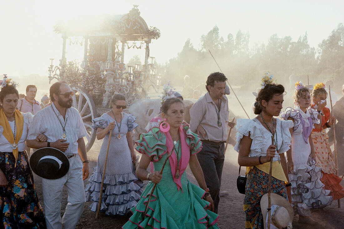Walking Pilgrims in the sanddust, Simpecado, ox carriage with symbol of the Virgin Mary, Romería al Rocío, El Rocío, pilgrimage, Andalusia, Spain
