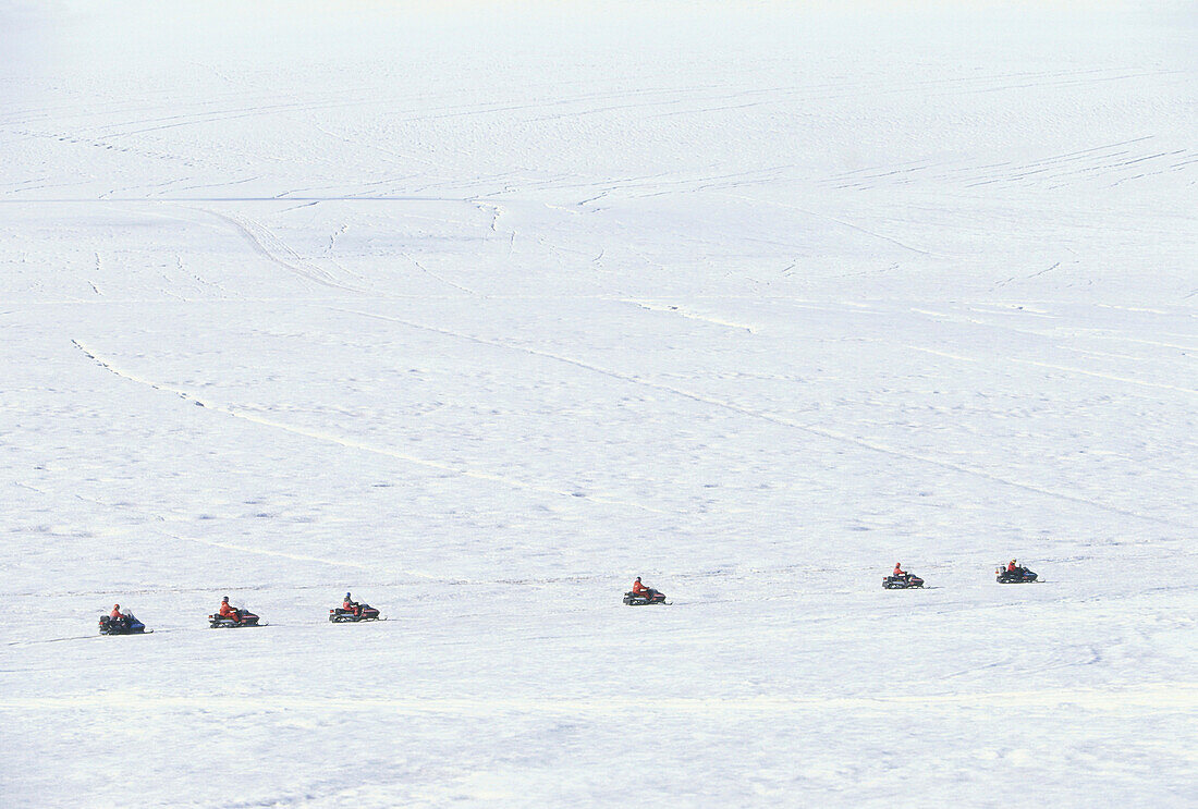 People driving snowmobiles on the Brokarjoekull, a glacial tongue of the Vatnajoekull, Island