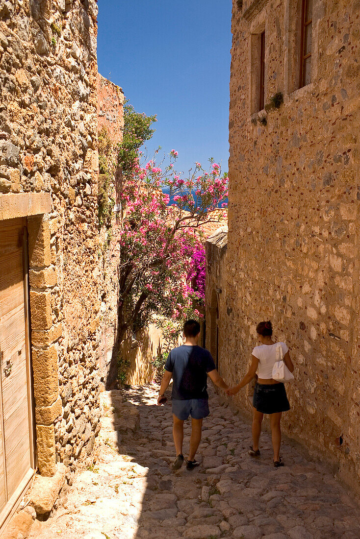 Paar läuft durch die Gassen in der mittelalterlichen Stadt Monemvasia, Lakonien, Peloponnes, Griechenland